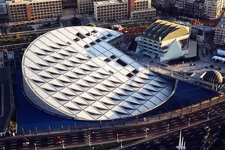 Aerial view of the Bibliotheca Alexandrina and its tilted circular roof with skylights in Alexandria