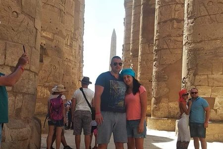 Sunlight streaming between towering carved columns of the Hypostyle Hall at Karnak Temple, Luxor